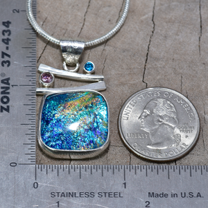 Fused dichroic glass pendant in a handmade setting of sterling silver accented with sparkly cubic zirconias. (N874)